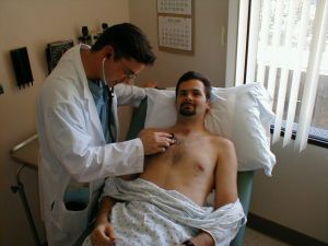 physician assistant auscultating a patient's heart